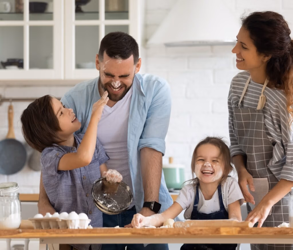 A family with young children baking together.
