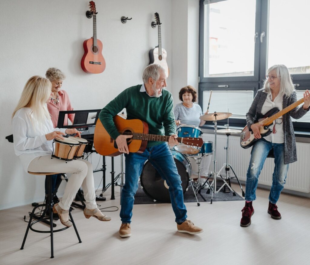 A group of people in their 50s playing musical instruments in a band.