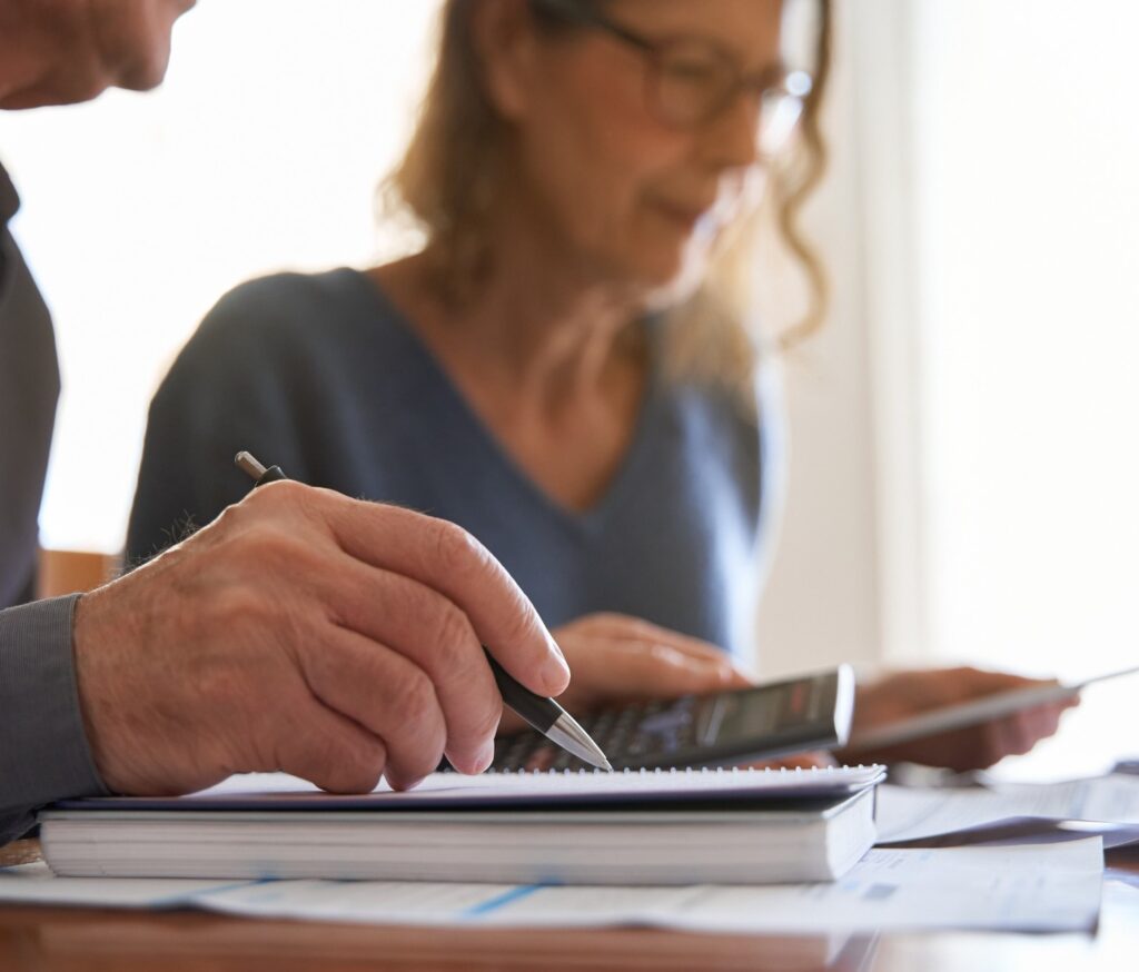 Couple looking at paperwork and using a calculator